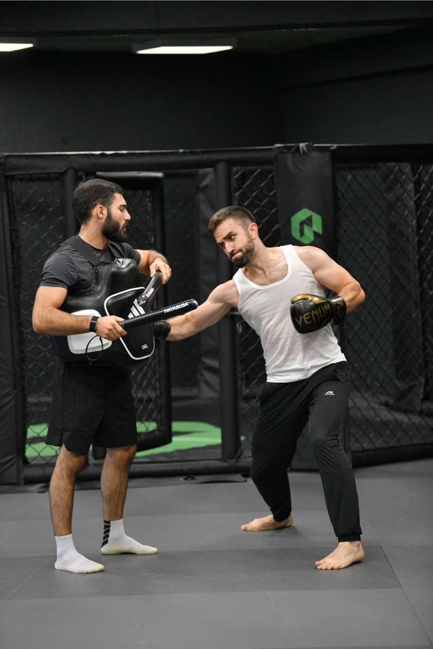 Kickboxing pad work session at the Gymnasia camp